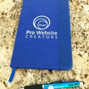 pwc notebook and pen showing compared to pen to see scale 1200w